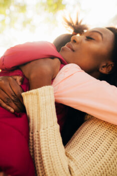 Mother hugging daughter (Photo courtesy of Canva)