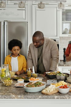 Family making food in kitchen